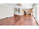 Open-concept living space with hardwood floors, seamlessly connects living room and kitchen at 1085 Crown River Pkwy, Mcdonough, GA 30252