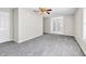 Large, open living room with neutral paint, carpet and white trim and moldings at 1085 Crown River Pkwy, Mcdonough, GA 30252