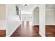 Open-concept living space with hardwood floors and seamlessly connects living and dining area at 1085 Crown River Pkwy, Mcdonough, GA 30252