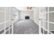 Open living room featuring fireplace, neutral color scheme and access to other rooms at 1085 Crown River Pkwy, Mcdonough, GA 30252