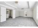 Open bedroom space featuring carpet, tray ceiling, ceiling fans and access to ensuite at 1085 Crown River Pkwy, Mcdonough, GA 30252