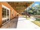 A covered patio area with stairs leading to the fenced yard at 1085 Crown River Pkwy, Mcdonough, GA 30252