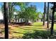 Spacious backyard with mature trees, grass lawn, and a deck off the home at 2648 Kenwood Dr, Duluth, GA 30096