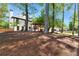 Expansive backyard featuring mature trees, a wooden pergola, and lush landscaping at 2648 Kenwood Dr, Duluth, GA 30096