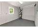 Spacious basement with gray epoxy flooring, wainscoting, and a small window at 2648 Kenwood Dr, Duluth, GA 30096