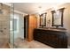 Bathroom with dual sinks, wood cabinets and a sauna at 2648 Kenwood Dr, Duluth, GA 30096