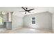An empty, carpeted bedroom featuring a ceiling fan, a window, and built-in shelves at 2648 Kenwood Dr, Duluth, GA 30096