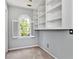 Bedroom featuring neutral carpet, gray walls, built-in shelves, and an arched window with shutters at 2648 Kenwood Dr, Duluth, GA 30096