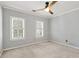 Bedroom featuring plush carpeting, neutral walls, and dual windows at 2648 Kenwood Dr, Duluth, GA 30096