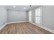 Neutral bedroom features light wood floors, shuttered windows and white trim at 2648 Kenwood Dr, Duluth, GA 30096