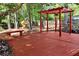 Large backyard deck with a pergola, bench, shade, and an amazing play area at 2648 Kenwood Dr, Duluth, GA 30096