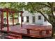 Backyard deck with a wooden pergola, bench seating, and access to yard at 2648 Kenwood Dr, Duluth, GA 30096
