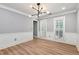 Dining room with light wood floors, paneled walls, and shuttered windows at 2648 Kenwood Dr, Duluth, GA 30096