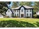 Charming two-story home featuring a manicured lawn and striking black and white accents at 2648 Kenwood Dr, Duluth, GA 30096