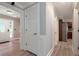 Inviting hallway with wood floors, white doors, and trim, leading to the front door and kitchen at 2648 Kenwood Dr, Duluth, GA 30096