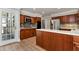 Kitchen showcases an island, dark wood cabinets, stainless steel appliances, and tiled backsplash at 2648 Kenwood Dr, Duluth, GA 30096