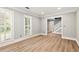 Bright living room with light wood floors, white trim, and windows with shutter blinds at 2648 Kenwood Dr, Duluth, GA 30096