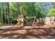 Backyard with a wooden playhouse featuring swings, slide, and climbing areas at 2648 Kenwood Dr, Duluth, GA 30096