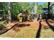 Backyard play area featuring a wooden playset, swing set, and slide at 2648 Kenwood Dr, Duluth, GA 30096