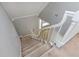 Carpeted staircase with white wooden railings, transitioning to a lower floor at 2648 Kenwood Dr, Duluth, GA 30096