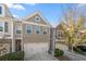 Charming exterior of a townhome with brick facade, attached two-car garage, and well-maintained landscaping at 2709 Kemp Court, Conyers, GA 30094