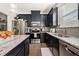 Modern kitchen with stainless steel appliances, granite countertops, and dark cabinets at 2709 Kemp Court, Conyers, GA 30094