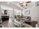 Open-concept living room featuring coffered ceilings, hardwood floors, and elegant furnishings at 2709 Kemp Court, Conyers, GA 30094