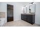 Bathroom boasts a granite vanity with dual mirrors and tiled tub surround at 4066 Harvest Ridge Dr, Douglasville, GA 30135