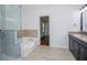 Bathroom showcasing a glass shower, step-up soaking tub, and a granite vanity at 4066 Harvest Ridge Dr, Douglasville, GA 30135