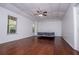 Large bedroom with hardwood floors, ceiling fan, and two windows at 4066 Harvest Ridge Dr, Douglasville, GA 30135