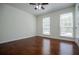A serene bedroom featuring rich hardwood floors and bright windows at 4066 Harvest Ridge Dr, Douglasville, GA 30135