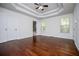 Spacious bedroom with tray ceiling, hardwood floors, and natural light from two windows at 4066 Harvest Ridge Dr, Douglasville, GA 30135