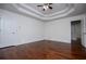Hardwood floors shine in this bedroom with a tray ceiling and fresh white walls at 4066 Harvest Ridge Dr, Douglasville, GA 30135