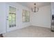 Bright dining room with tile flooring, a modern chandelier, and a door leading to the deck at 4066 Harvest Ridge Dr, Douglasville, GA 30135