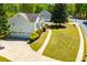 Aerial view of the house showing a three car garage and lush landscaping on a corner lot at 4066 Harvest Ridge Dr, Douglasville, GA 30135