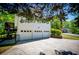 Spacious three-car garage with concrete driveway and siding at 4066 Harvest Ridge Dr, Douglasville, GA 30135