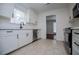 Modern kitchen featuring stainless steel appliances, white cabinets, and light tile flooring at 4066 Harvest Ridge Dr, Douglasville, GA 30135