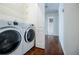 Well-equipped laundry area with white appliances and easy access to the hallway at 4066 Harvest Ridge Dr, Douglasville, GA 30135