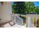 A cozy porch view, showcasing the white railing, tile flooring, and glimpses of the outdoors at 4066 Harvest Ridge Dr, Douglasville, GA 30135