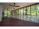Large screened-in porch with wooden floor, ceiling fans, and a white lattice railing at 4066 Harvest Ridge Dr, Douglasville, GA 30135
