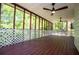 Screened-in porch with a wood deck, ceiling fans, and an enclosed fence at 4066 Harvest Ridge Dr, Douglasville, GA 30135