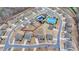 A community aerial view of homes with a pool, tennis court, and other neighborhood features at 5525 Nesmith Ct, Cumming, GA 30040