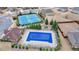 Aerial view of community pool, tennis courts, and playground surrounded by green spaces for Gathering entertainment at 5525 Nesmith Ct, Cumming, GA 30040