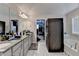 Luxurious bathroom featuring double vanities and a soaking tub at 5525 Nesmith Ct, Cumming, GA 30040