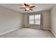 Large bedroom with neutral paint and carpet and large window at 5525 Nesmith Ct, Cumming, GA 30040
