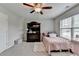 Comfortable bedroom featuring a ceiling fan and a view of the neighborhood at 5525 Nesmith Ct, Cumming, GA 30040
