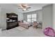 Cozy bedroom featuring natural light, a ceiling fan, and ample closet space at 5525 Nesmith Ct, Cumming, GA 30040