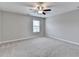 Large bedroom with neutral paint and carpet and large window at 5525 Nesmith Ct, Cumming, GA 30040
