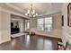 Dining room with hardwood floors, a chandelier, and decorative molding at 5525 Nesmith Ct, Cumming, GA 30040