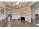 Spacious dining room featuring hardwood floors, wainscoting, and large windows at 5525 Nesmith Ct, Cumming, GA 30040